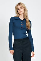Woman wearing blue knitted long sleeve top