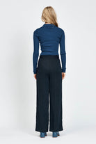 Woman wearing blue knitted long sleeve top