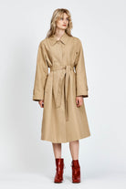 Model wearing beige trench coat