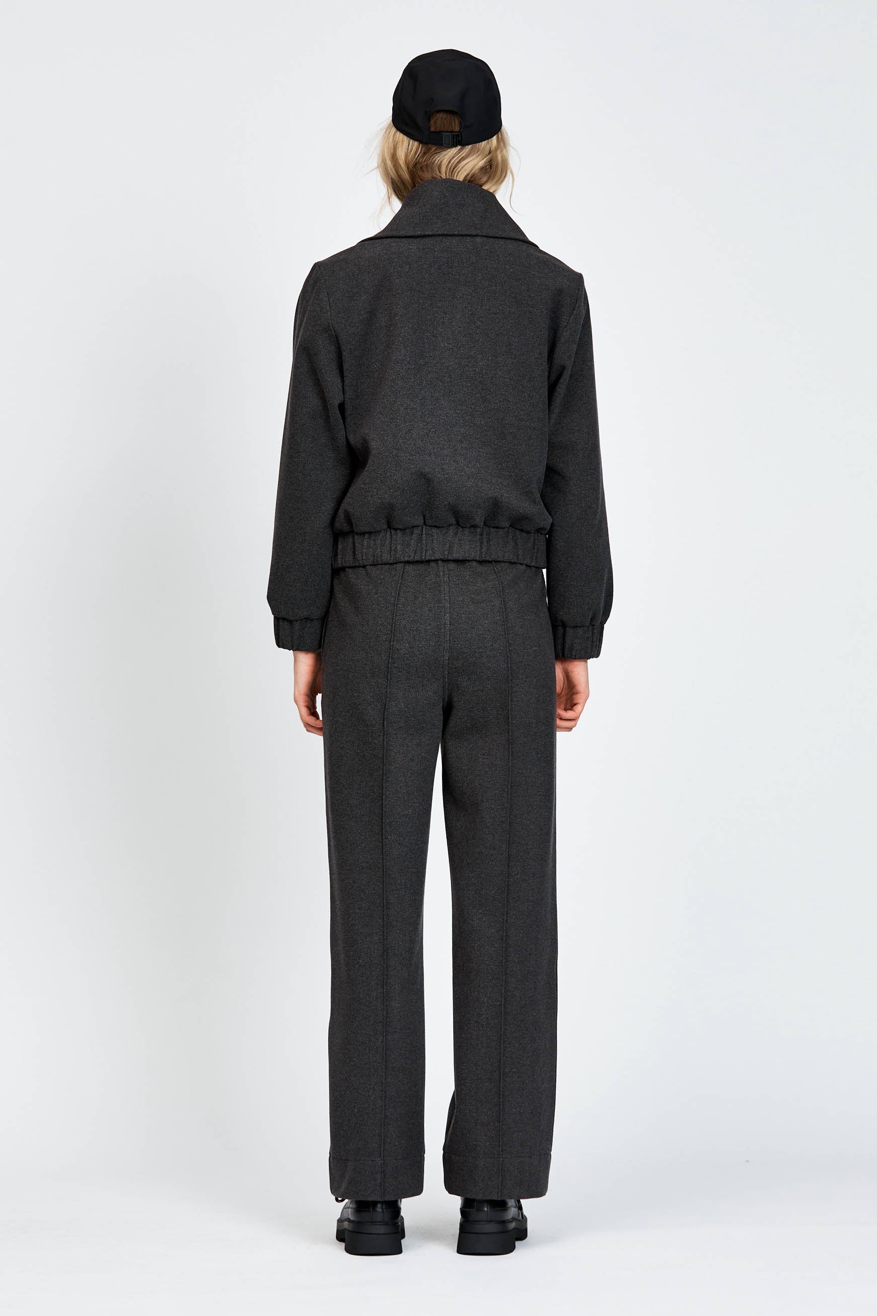 Model wearing relaxed silhouette charcoal pant