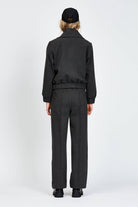 Model wearing a black jacket with zipper