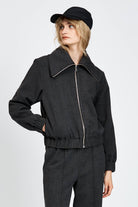 Model wearing a black jacket with zipper