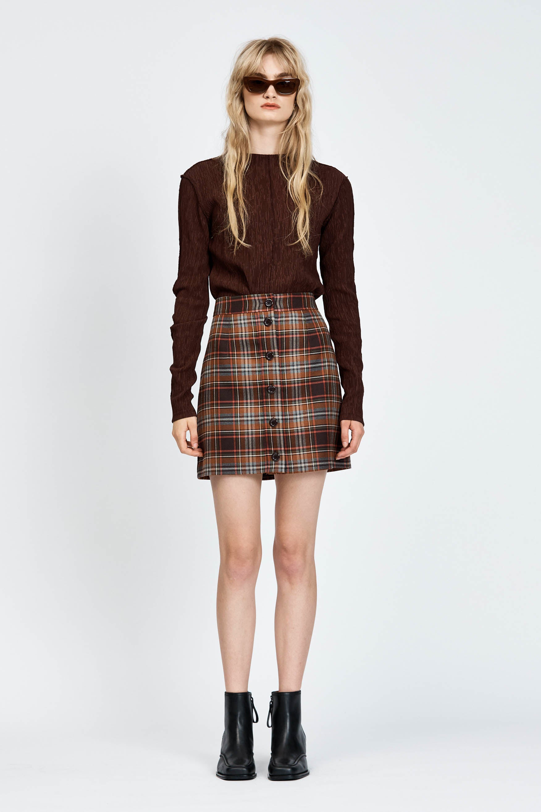 Woman wearing brown check mini skirt