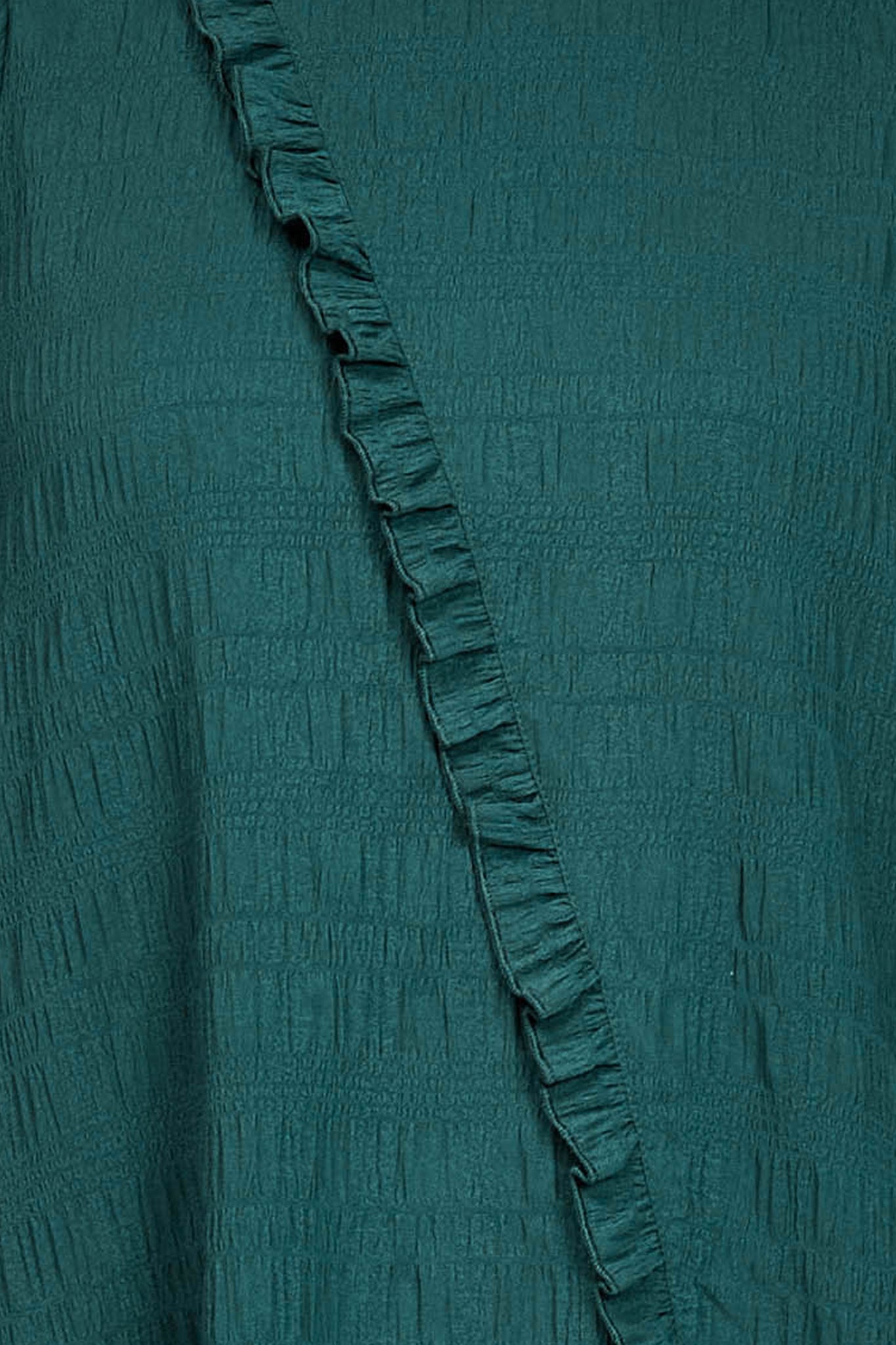 Fabric swatch of the green fabric of the dress
