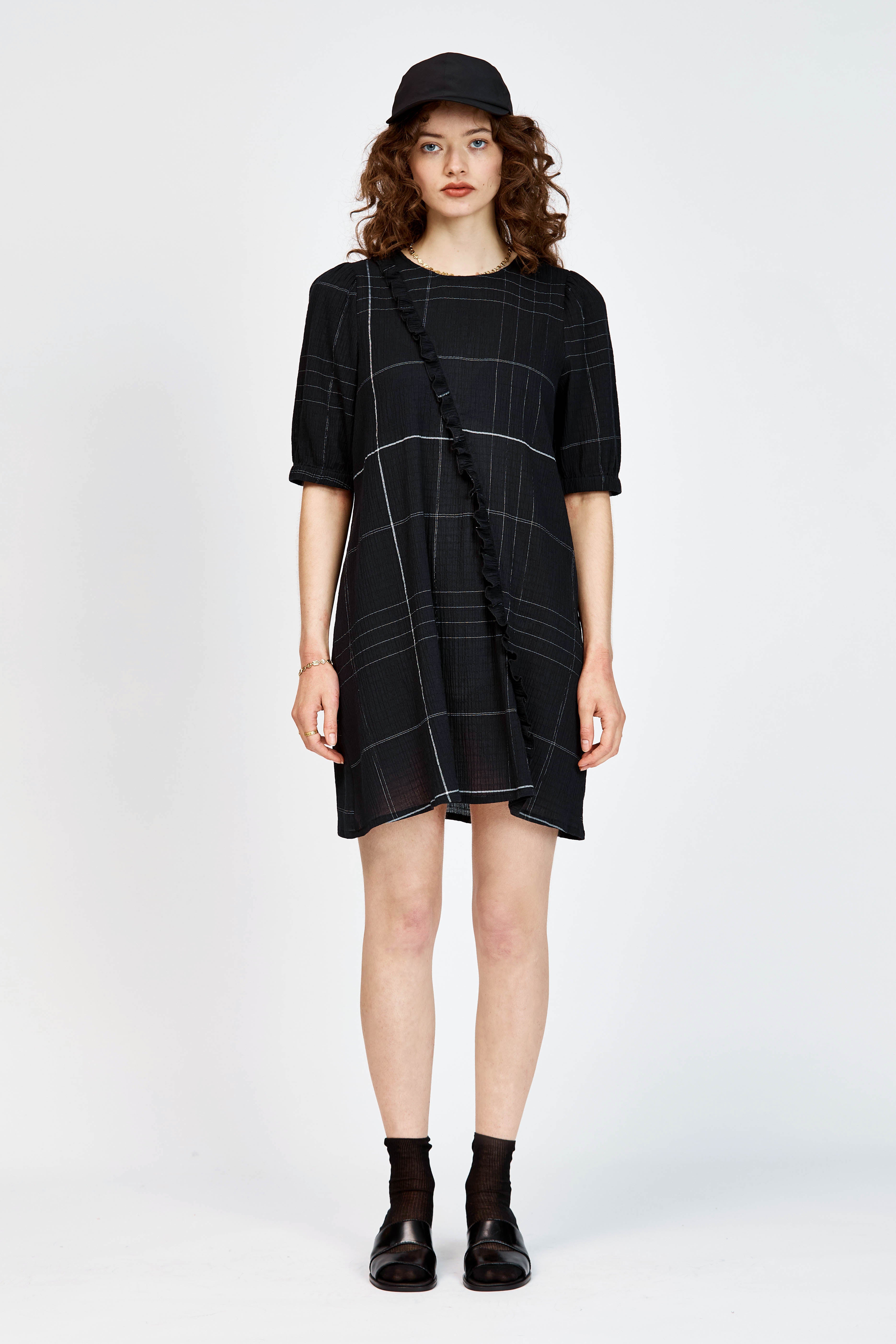 Model wearing a black and white check mini dress