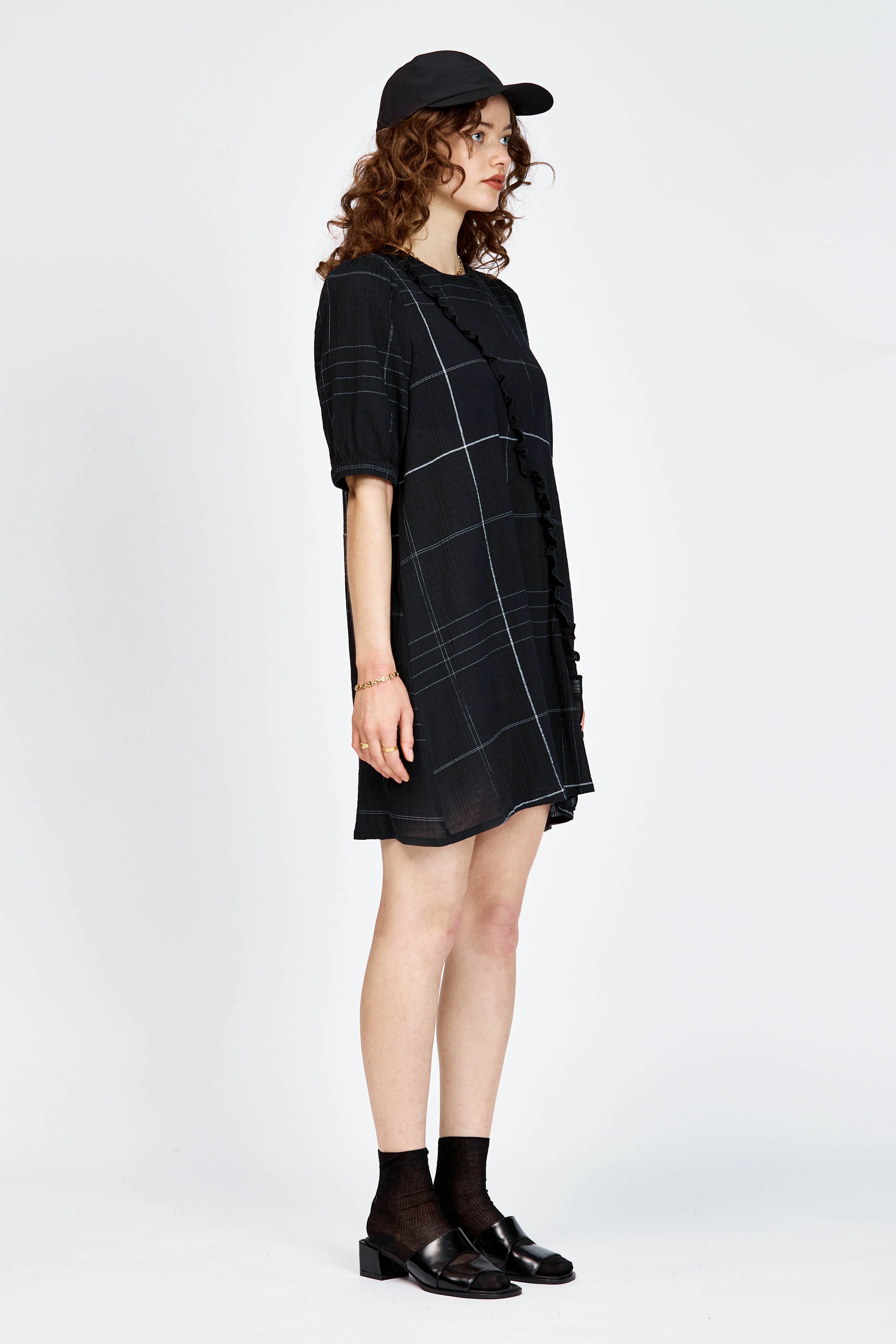 Model wearing a black and white check mini dress