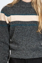 Woman wearing a soft woollen jumper in grey