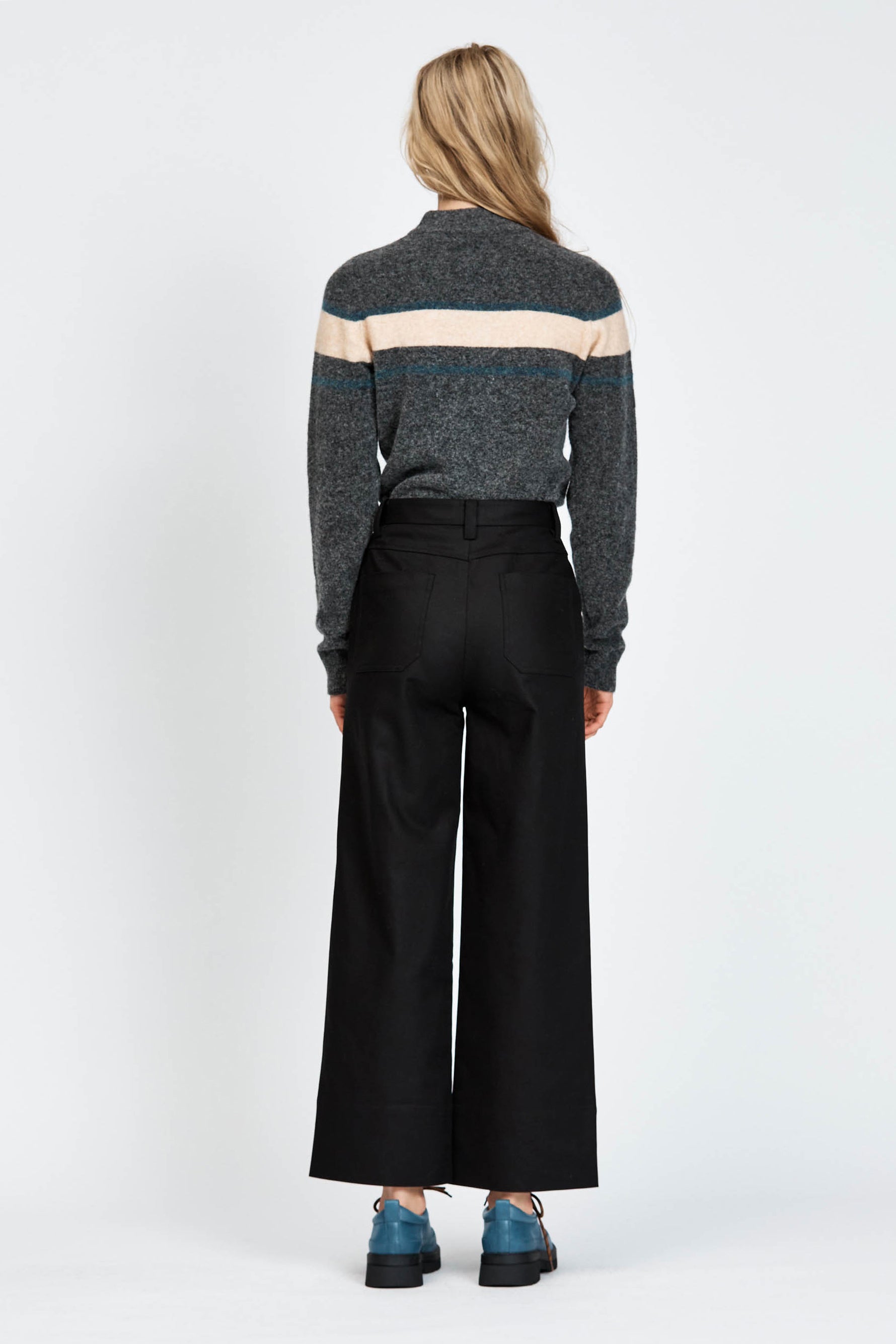 Woman wearing a soft woollen jumper in grey