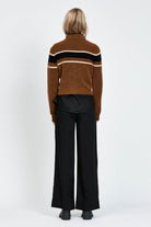 Woman wearing a woollen brown jumper