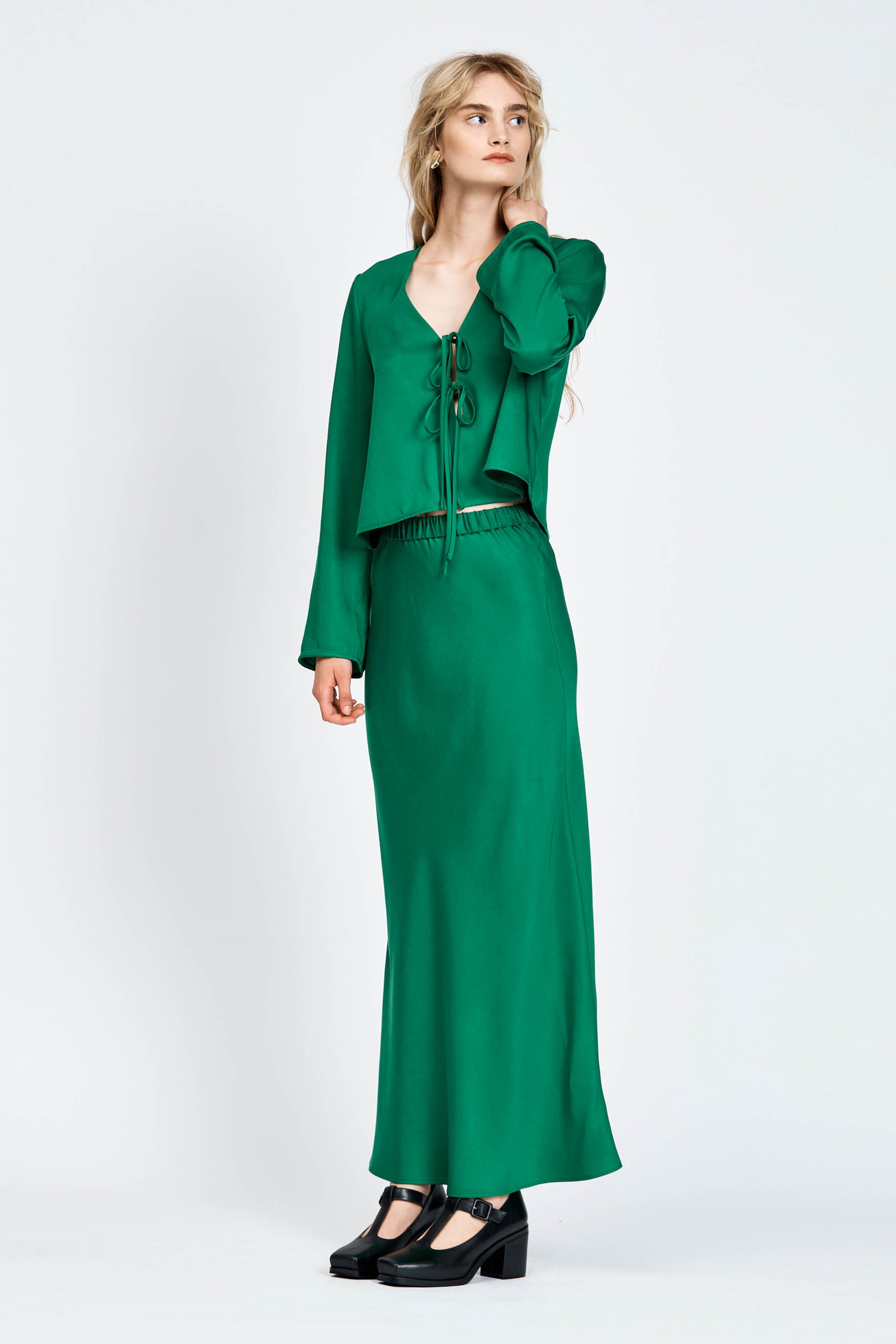 Model wearing green midi length skirt