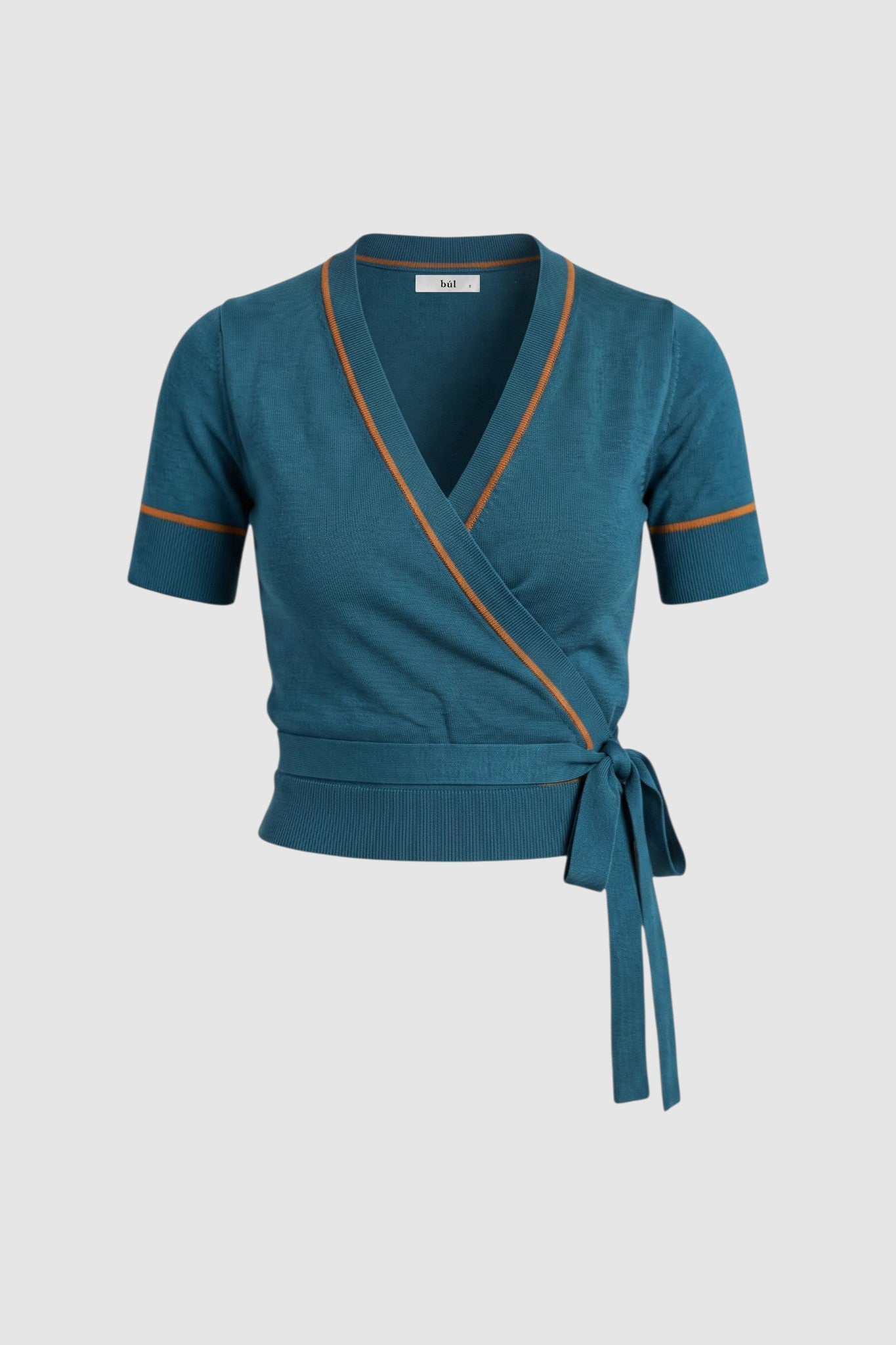Silo image of teal wrap-style short-sleeve top with thin orange trim along V-neckline and armholes