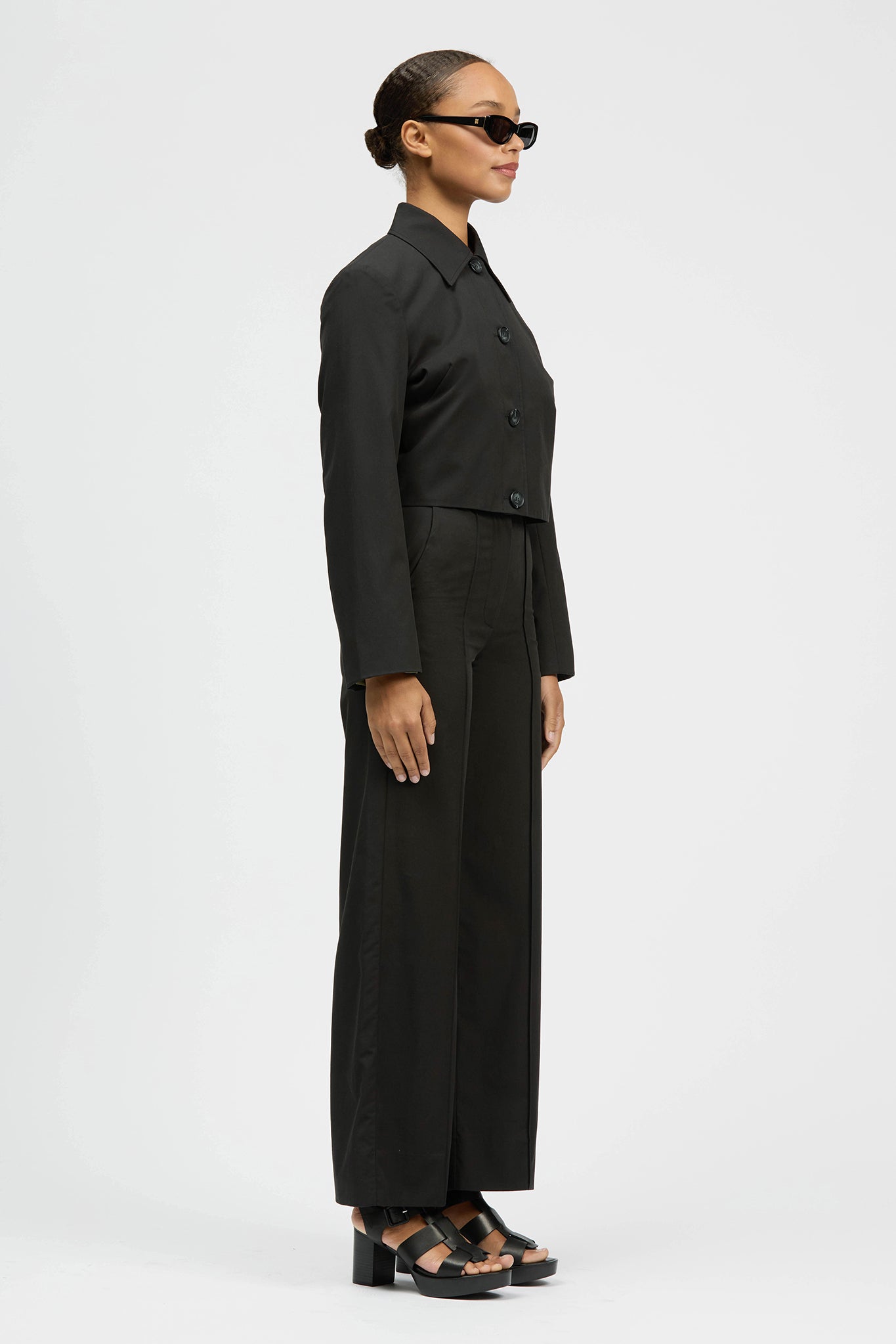 Woman wearing black cropped jacked with buttons