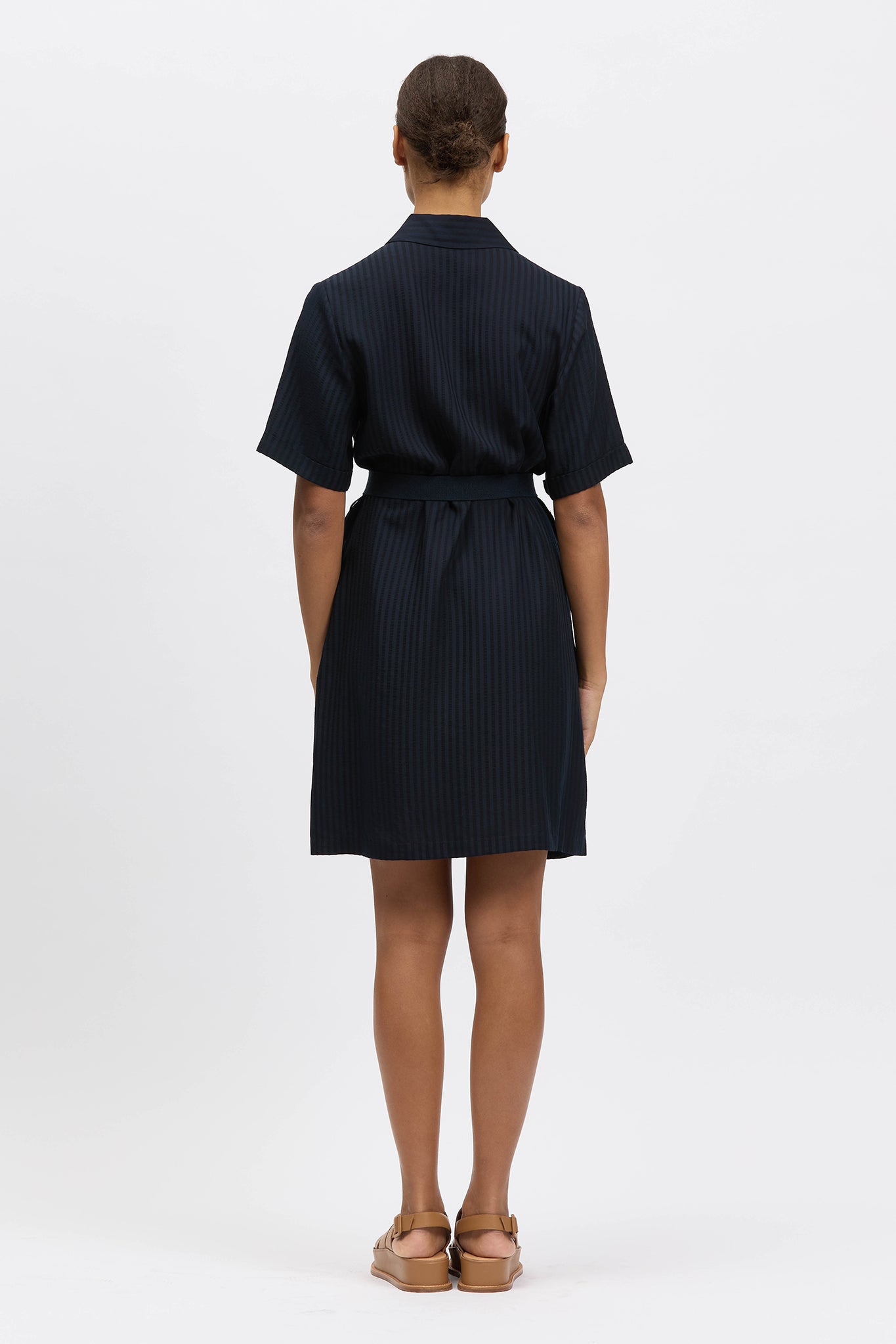 Woman wearing navy shirt dress
