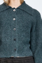 Woman wearing a fluffy woollen cardigan in navy