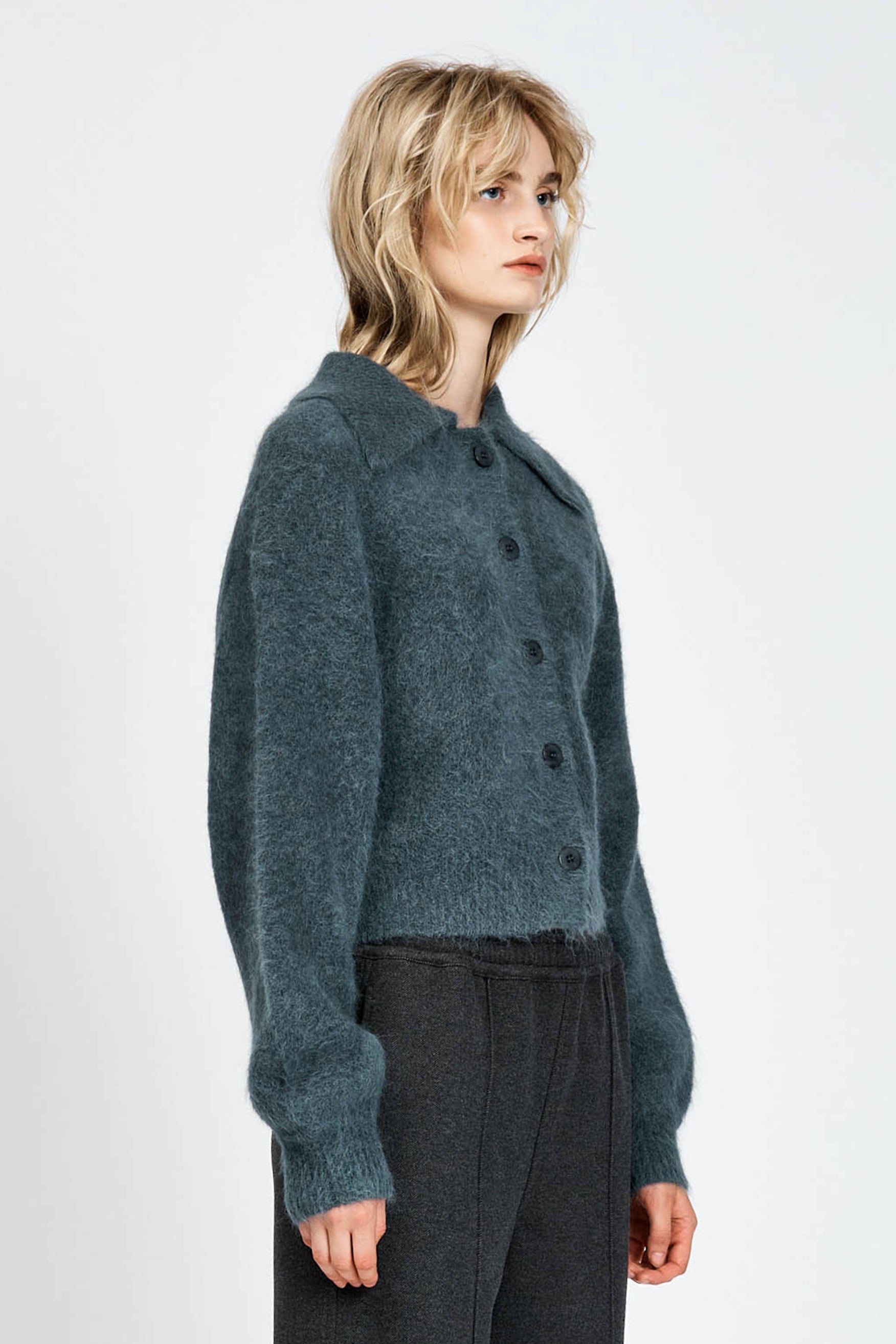 Woman wearing a fluffy woollen cardigan in navy