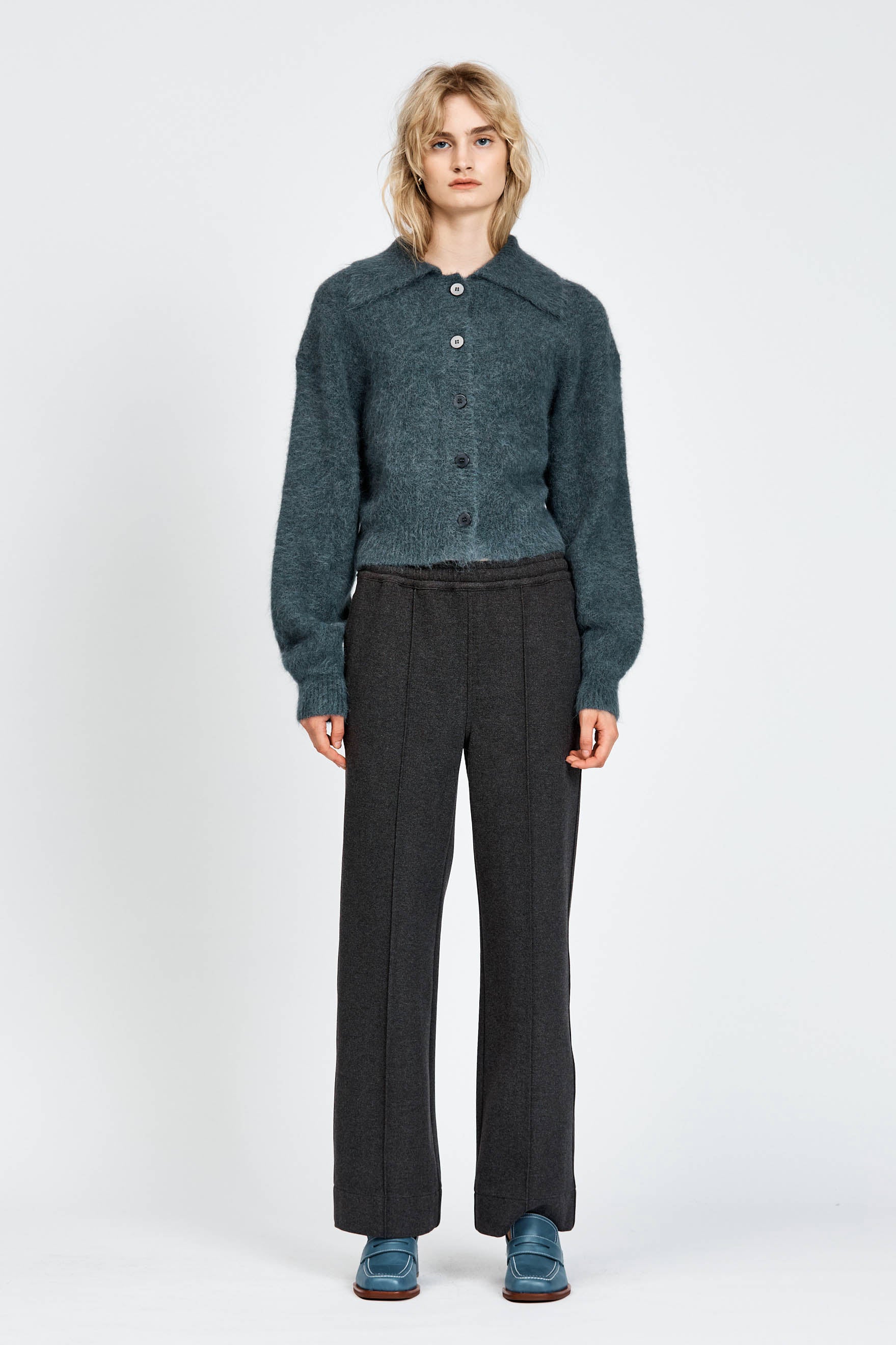 Woman wearing a fluffy woollen cardigan in navy