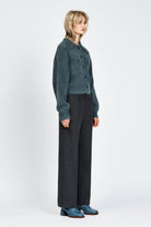 Woman wearing a fluffy woollen cardigan in navy