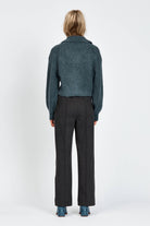 Woman wearing a fluffy woollen cardigan in navy