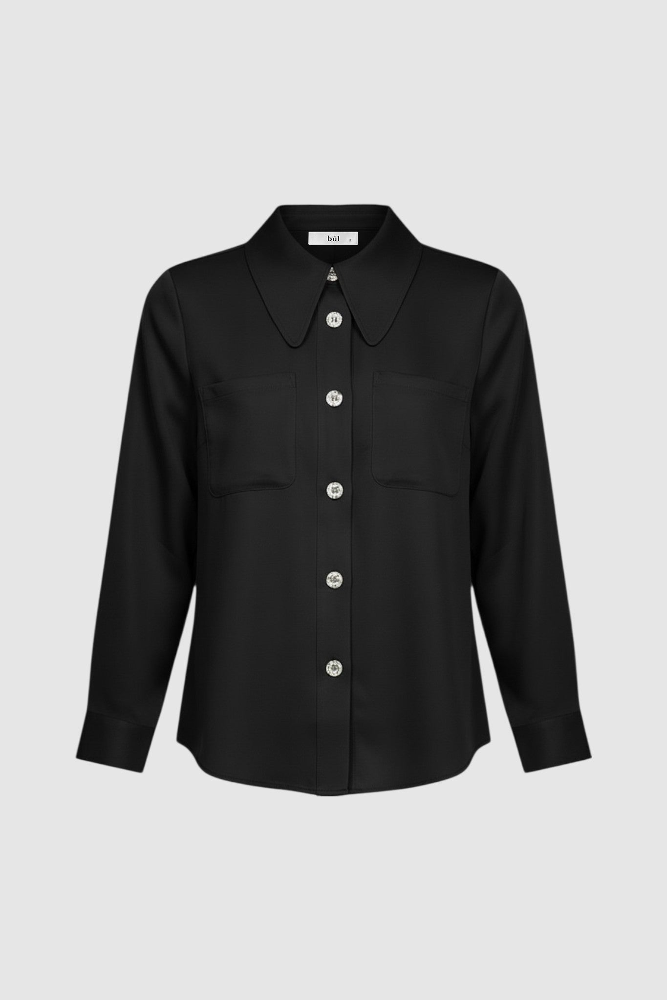 Woman wearing a long sleeve black shirt with white buttons
