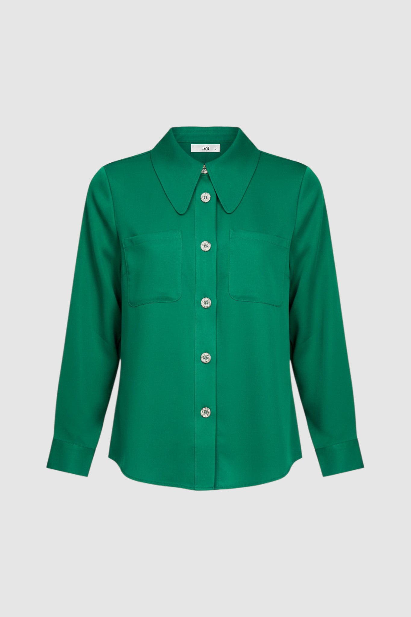 Woman wearing a green long sleeve shirt with white buttons