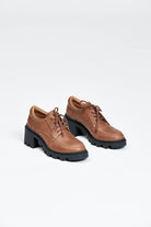 Brown leather lace up show with black sole and heel
