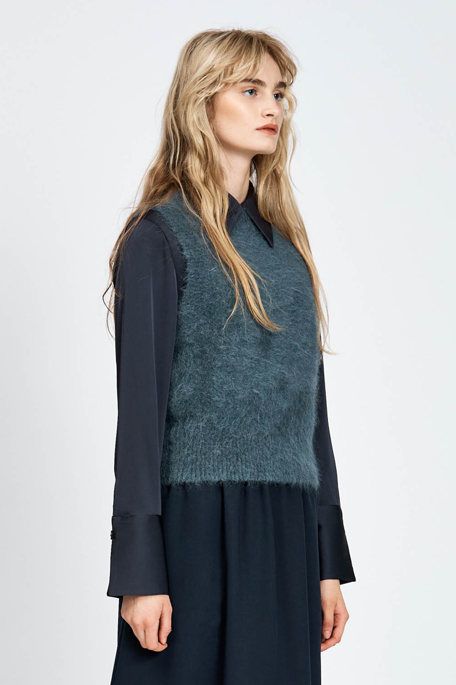 Woman wearing a navy woollen vest