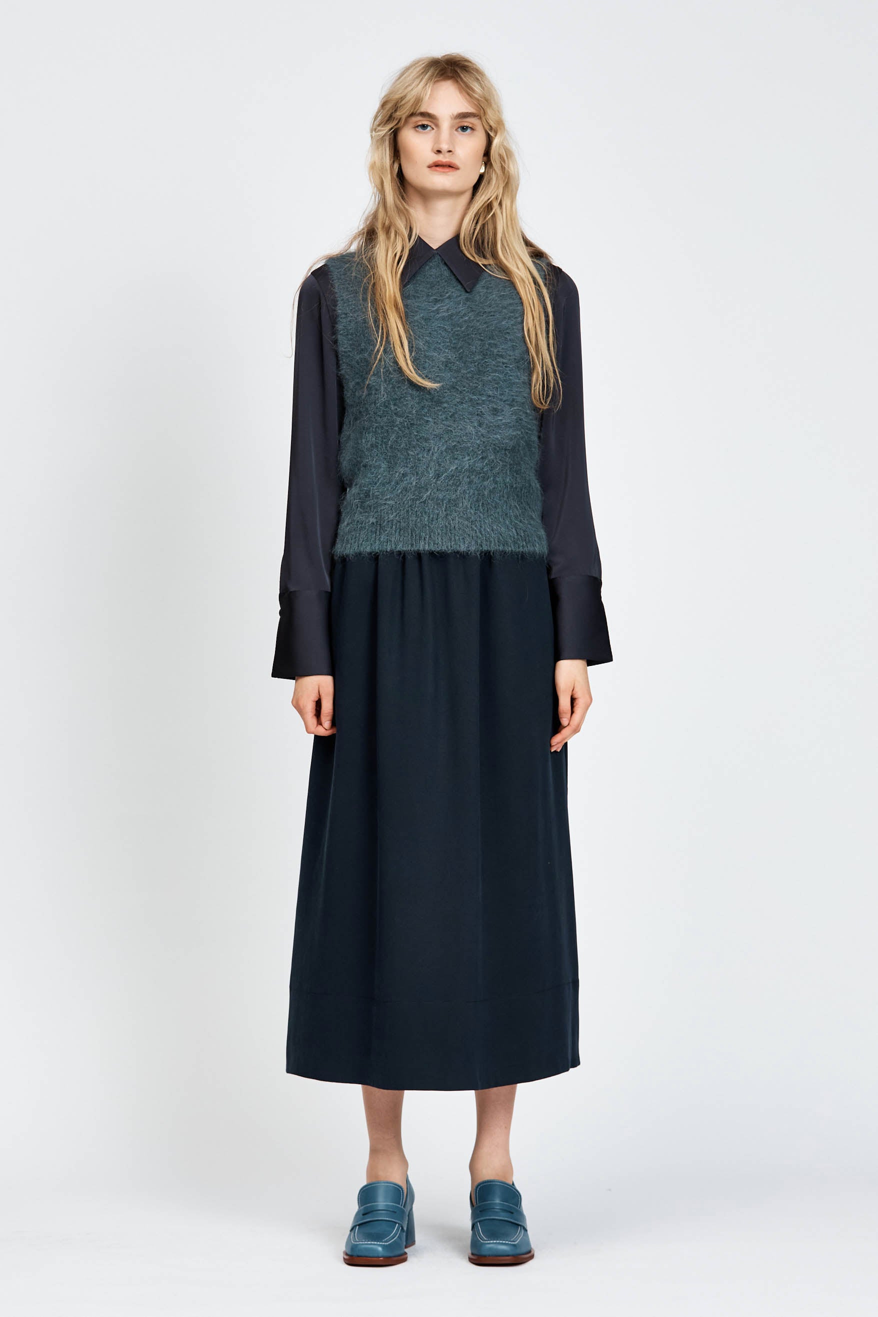 Woman wearing a navy woollen vest