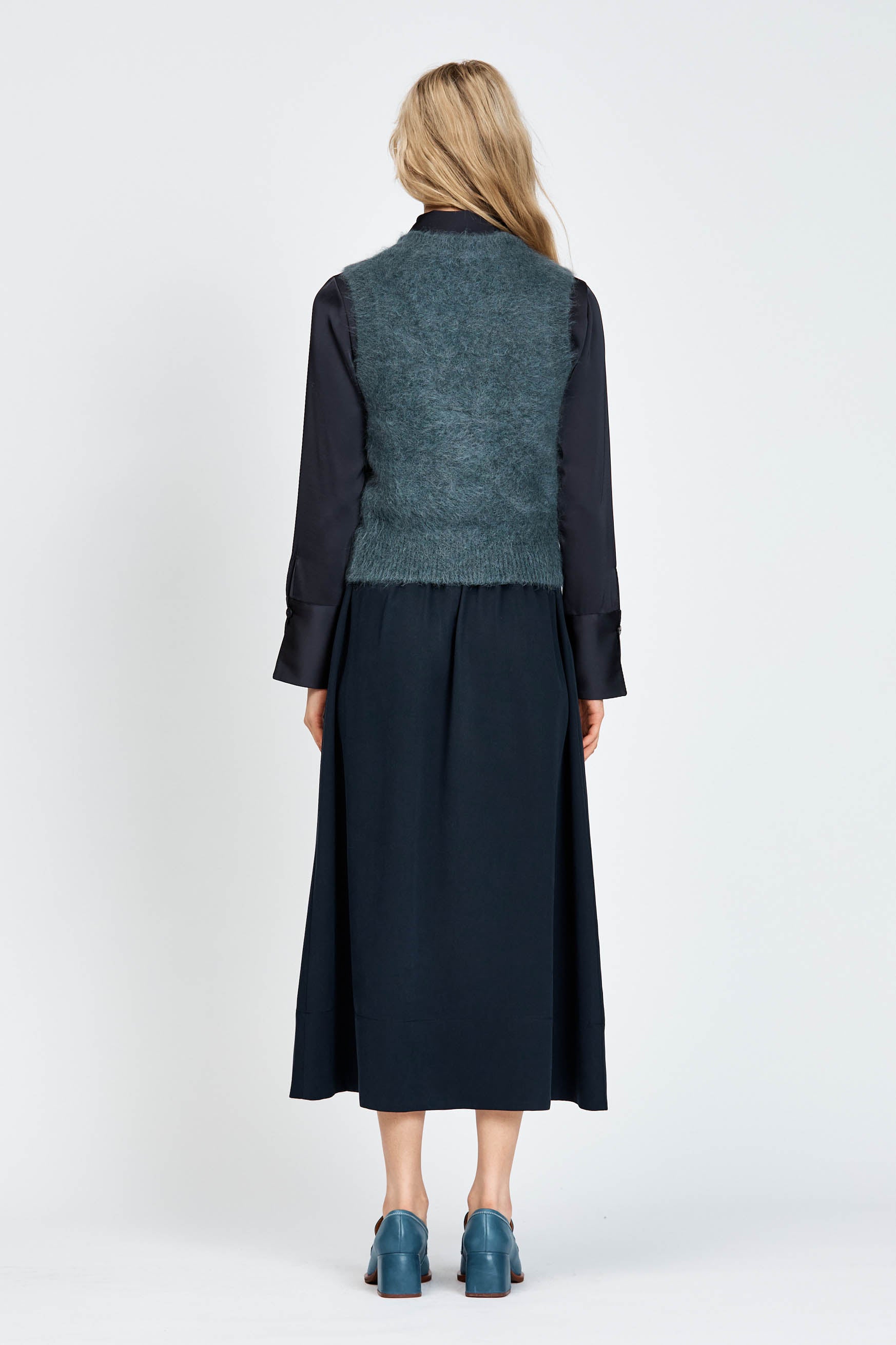 Woman wearing a navy woollen vest