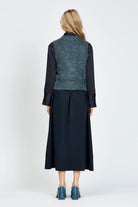 Woman wearing a navy woollen vest