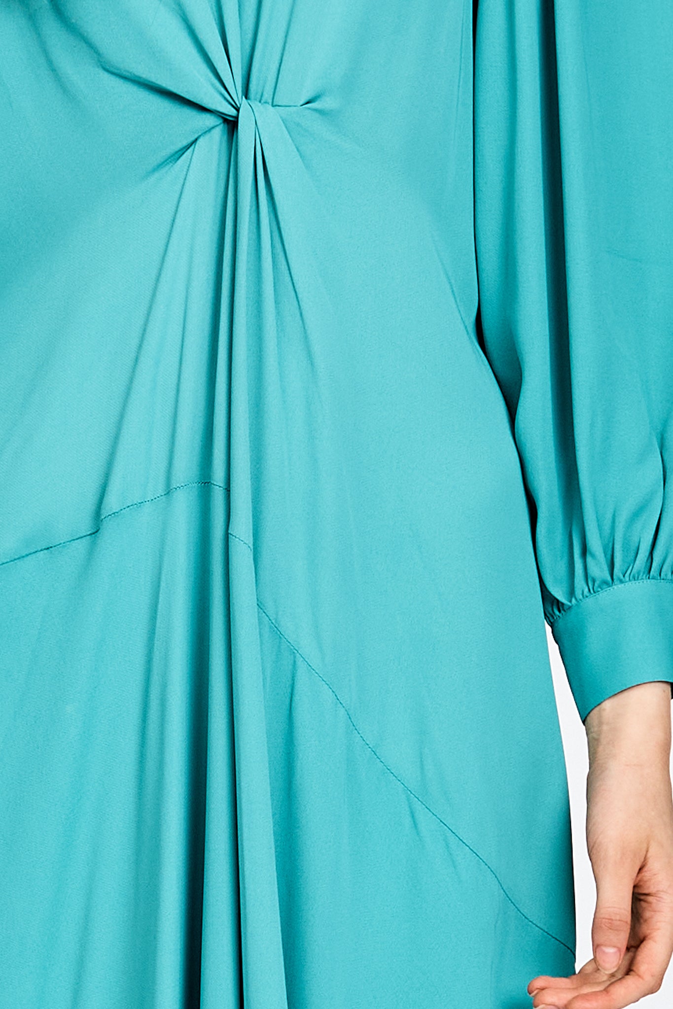 Model wearing a long sleeve green dress
