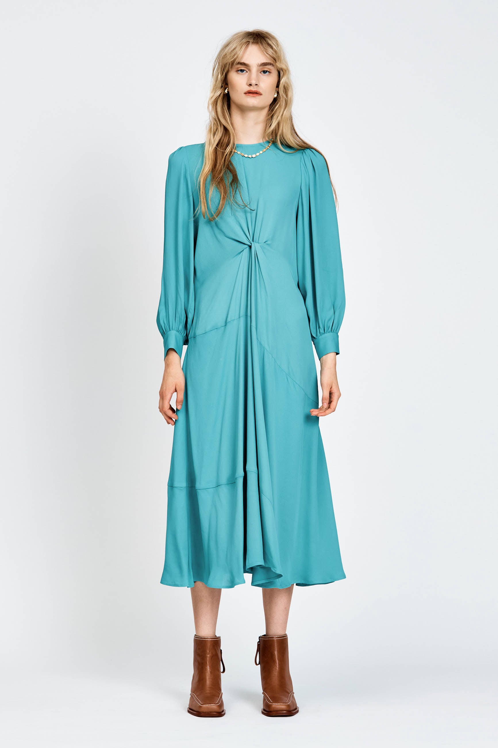 Model wearing a long sleeve green dress