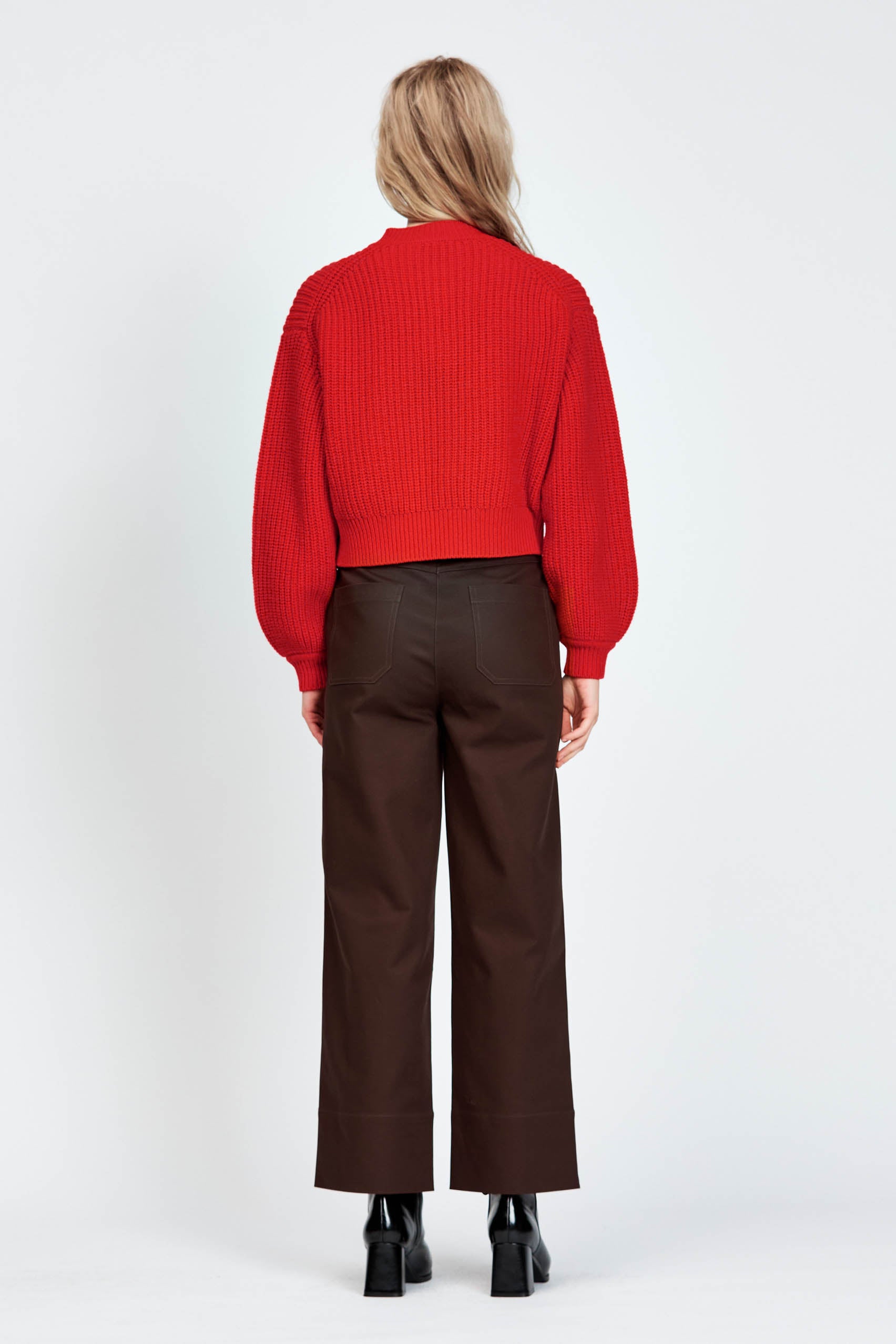 Woman wearing cable knit cardigan in red