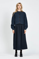 Woman wearing cable knit cardigan in navy