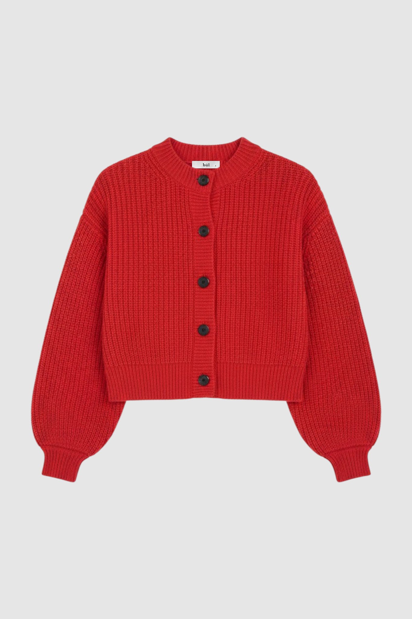 Woman wearing cable knit cardigan in red
