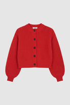 Woman wearing cable knit cardigan in red