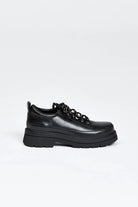 Black shoe with round toe and black and white contrast laces