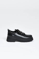 Black shoe with round toe and black and white contrast laces