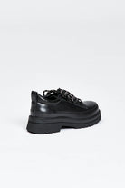 Black shoe with round toe and black and white contrast laces