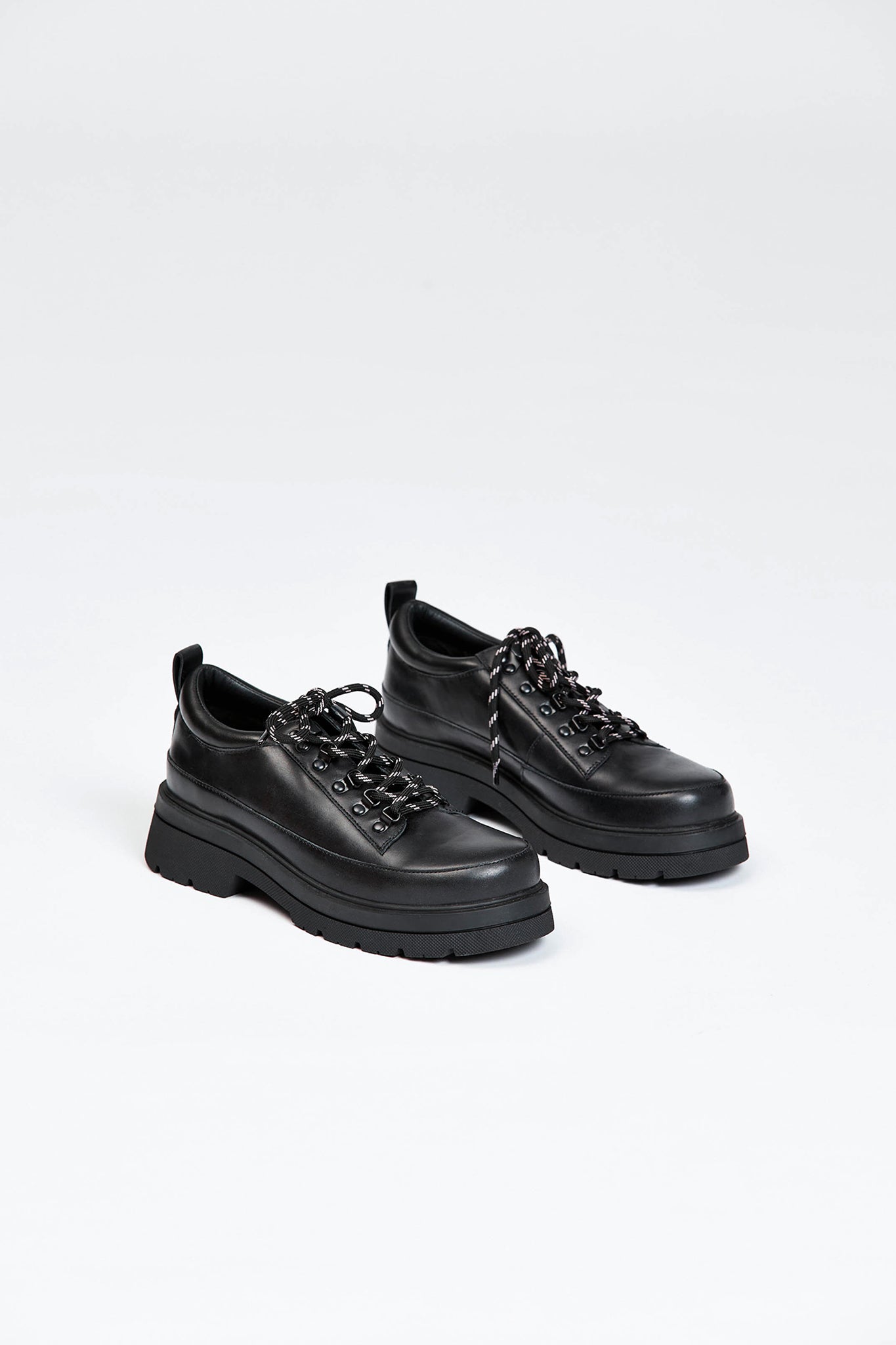 Black shoe with round toe and black and white contrast laces