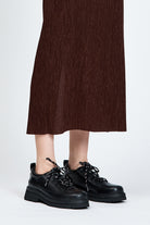 Black shoe with round toe and black and white contrast laces